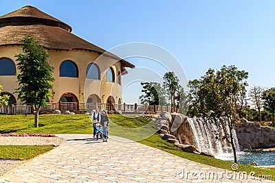 Amily walking near an artificial waterfall in Dubai safari park Editorial Stock Photo