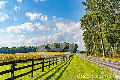 Amish country field agriculture, beautiful brown wooden fence, farm, barn in Lancaster, PA US Stock Photo