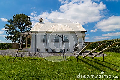 Amish School House with swings and seesaw Stock Photo