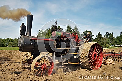 Amish steam tractor engine plowing the field Editorial Stock Photo