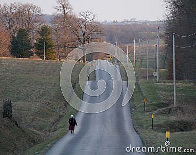 Amish woman on a wavy road Editorial Stock Photo