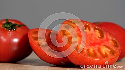 Wet slices of tomatoes. Ripe natural tomato close-up. Half of Tomato close-up. Stock Photo