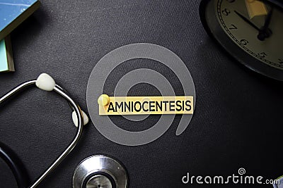 Amniocentesis text on Sticky Notes. Top view isolated on black background. Healthcare/Medical concept Stock Photo