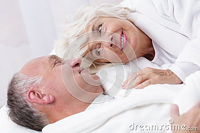 Amorous senior couple in bed Stock Photo