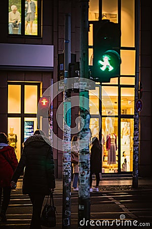 Ampelman walk sign in Berlin with people crossing the street Editorial Stock Photo