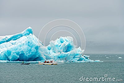 Amphibian vehicle with tourists in Jokulsarlon/Fjallsarlon glacier lagoon by the foot of Vatnajokull volcano. Stock Photo