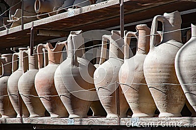 Amphora in a row on a shelf Stock Photo