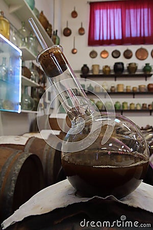 Ampoule of very old Balsamico on an old cask containing balsamico Stock Photo