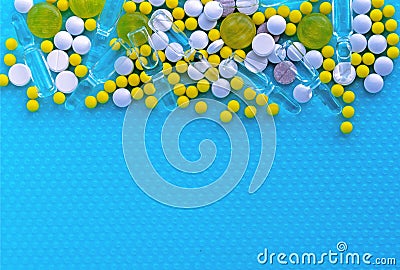 Ampoules for injection, pills and vitamins on a blue background. Medical concept Stock Photo