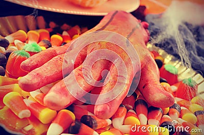 Amputated hand and Halloween candies, filtered Stock Photo