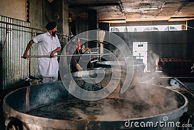 Amritsar, India - AUGUST 15: Cooks preparing food portion for pilgrims. The Kitchen at Golden Temple Feeds up to 100,000 People a Editorial Stock Photo