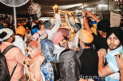 Sikh people trying to touch the holi idol when it was taken out of the temple premises for Editorial Stock Photo