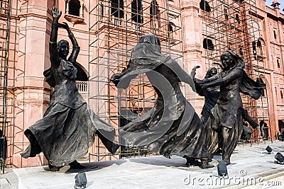 Amritsar, India: Dancing girls statue doing Punjabi folk group dance representing Punjab culture near Golden Editorial Stock Photo