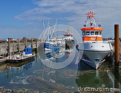 Amrum, Germany - May 27th, 2016 - Harbor on the island of Amrum with fishing boats and life boat Editorial Stock Photo