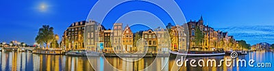 Amstel river, canals and night view of beautiful Amsterdam city. Netherlands. Stock Photo