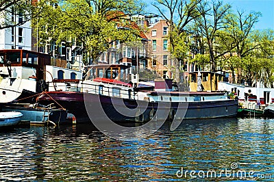 Amsterdam, Amstel river, boats, Netherlands, Europe and colorful buildings Stock Photo