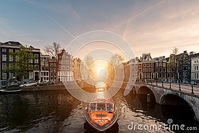 Amsterdam canal cruise ship with Netherlands traditional house i Stock Photo