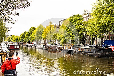 Amsterdam canal moored boats Editorial Stock Photo