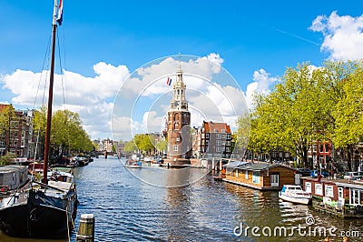 Amsterdam cityscape and the Montelbaanstoren tower on the left. The canal Oudeschans, the Netherlands. Stock Photo