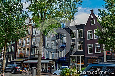 Amsterdam, Holland, August 2019. The typical and charming houses: they are a symbol of the city represented on a postcard. With Editorial Stock Photo