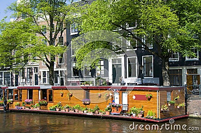 Amsterdam holland canal house boat with flowers Stock Photo