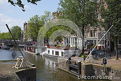 Boat lock on the Korte Prinsengracht and houseboat with flowers Editorial Stock Photo