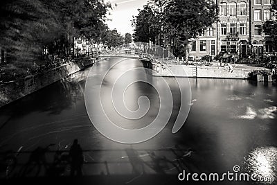 Amsterdam, Holland, the Netherlands - July 6 2020: capture of the typical Amsterdam scenery at a water crossing of a canal staging Editorial Stock Photo