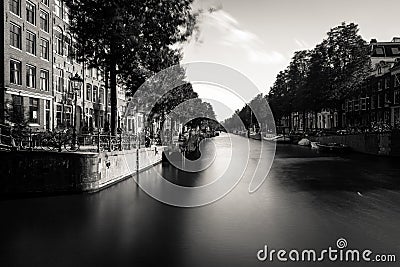 Amsterdam, Holland, the Netherlands - July 6 2020: capture of the typical Amsterdam scenery at a water crossing of a canal staging Editorial Stock Photo