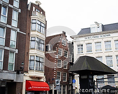 Leaning and tilting houses in Amsterdam along the canal. Traditional Dutch Editorial Stock Photo