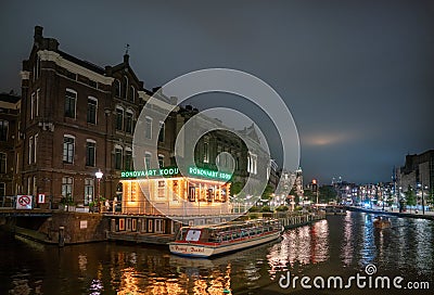 Night view over the last part of the Rokin where still water is with in the foreground the office of the canal cruise comapny Kooi Editorial Stock Photo