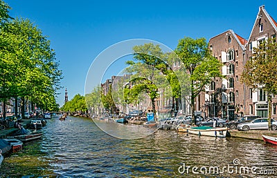 Amsterdam, May 7 2018 - The Prinsengracht with small boats sailing on it and in the background the Westertoren on a sunny day Editorial Stock Photo