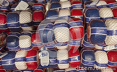 Amsterdam, Nederland. Shop window of a food store with traditional Dutch cheeses. Red, white, and blue plastic packaging Editorial Stock Photo