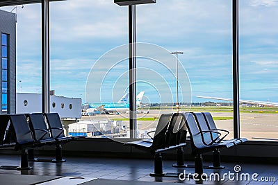 Amsterdam Airport Schiphol AMS terminal with empty seats and no passengers during coronavirus COVID-19 pandemic Editorial Stock Photo