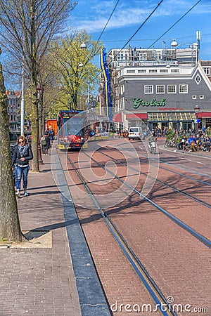 Amsterdam, Netherlands - April 09, 2019: Classic bicycles and historical houses in old Amsterdam. Typical street in Amsterdam with Editorial Stock Photo