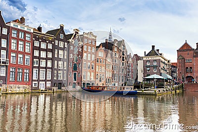 AMSTERDAM, NETHERLANDS - APRIL 29, 2016: Typical old colorful dutch houses standing on the canal Editorial Stock Photo