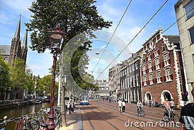 AMSTERDAM; THE NETHERLANDS - AUGUST 19; 2015: View of Singel street and De Krijtberg church from Koningsplein. Street life, canal Editorial Stock Photo