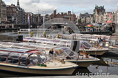 Canal tour boats moored and waiting for passengers. Urban landscape Editorial Stock Photo