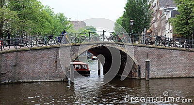 Amsterdam, The Netherlands, city canals, boats, bridges and streets. Unique beautiful and wild European city. Stock Photo