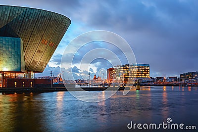 Panorama of the Oosterdok canal in Amsterdam with the back of Nemo Science Museum on the left. Editorial Stock Photo