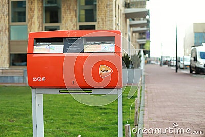 Dutch PostNL orange post box with logo Editorial Stock Photo