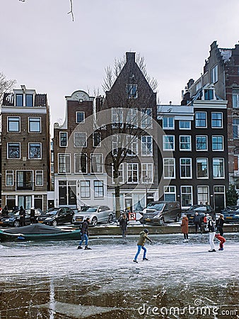 Amsterdam Netherlands, frozen canals and people ice skating in Amsterdam Editorial Stock Photo