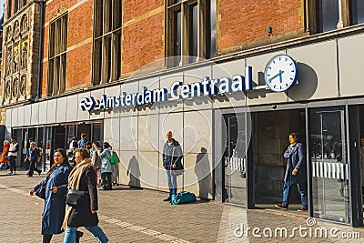 04.18.2023 Amsterdam, Netherlands. International railway hub Amsterdam Centraal, tourists entering railway station Editorial Stock Photo