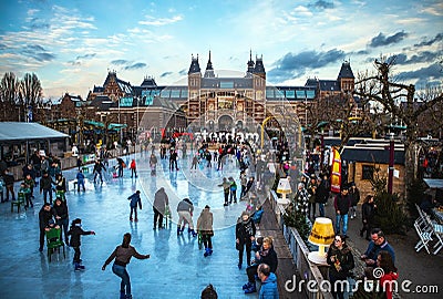 AMSTERDAM, THE NETHERLANDS - JANUARY 15, 2016: Many people skate on winter ice skating rink in front of the Rijksmuseum, a popular Editorial Stock Photo