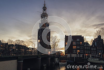 View on the canal Oudeschans at Sunset with the tower Montelbaanstoren in the background in Amsterdam Editorial Stock Photo