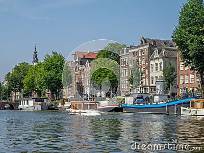 Boats along Amsterdam`s beautiful canals Editorial Stock Photo