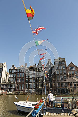 Jetty with pleasure ships on Damrak street in the center of Amsterdam Editorial Stock Photo