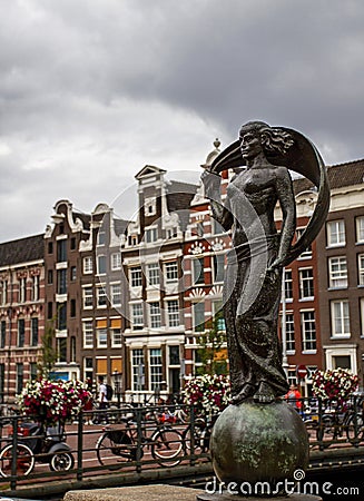 AMSTERDAM- NETHERLANDS, on JULY 12, 2017.Lady fortune, Vrouwe Fortuna,on the background traditional dutch medieval buildings. Editorial Stock Photo