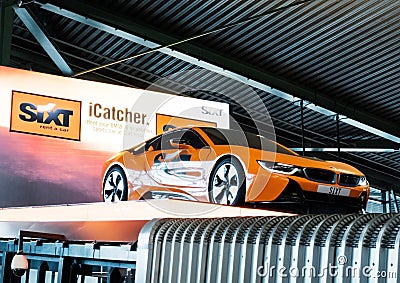 AMSTERDAM, NETHERLANDS - JULY 18, 2018: SIXT rental car billboard with luxury car in Schiphol Editorial Stock Photo
