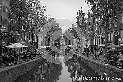 AMSTERDAM, NETHERLANDS. JUNE 06, 2021. Beautiful view of Amsterdam with typical dutch houses, bridges and chanel. Black and white Editorial Stock Photo