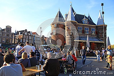 People in outdoor cafe on Nieuwmarkt New Market square in cent Editorial Stock Photo